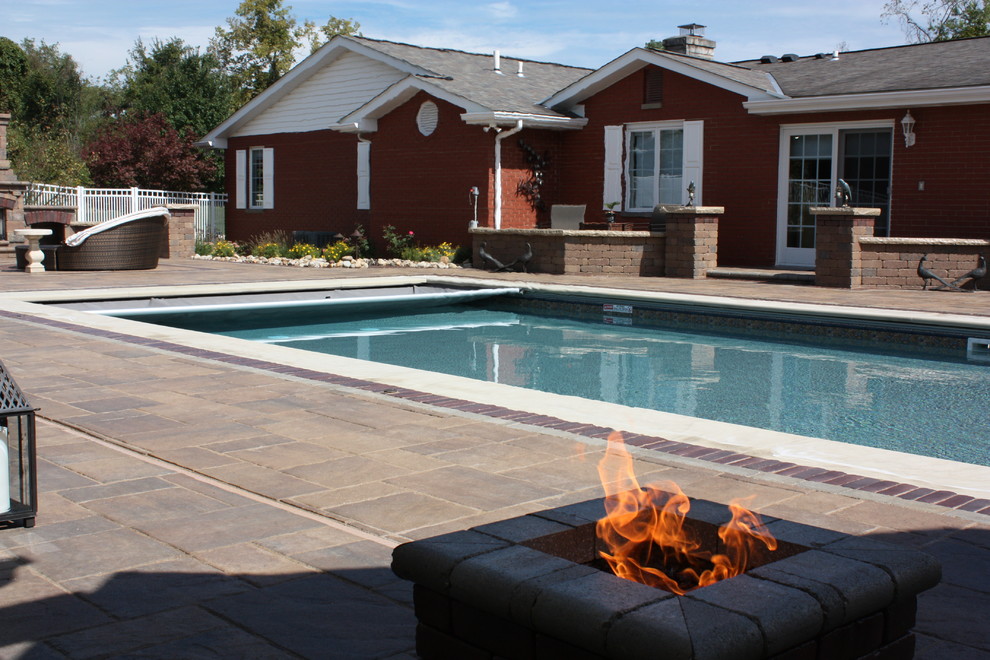 Mid-sized transitional backyard concrete paver and rectangular lap pool photo