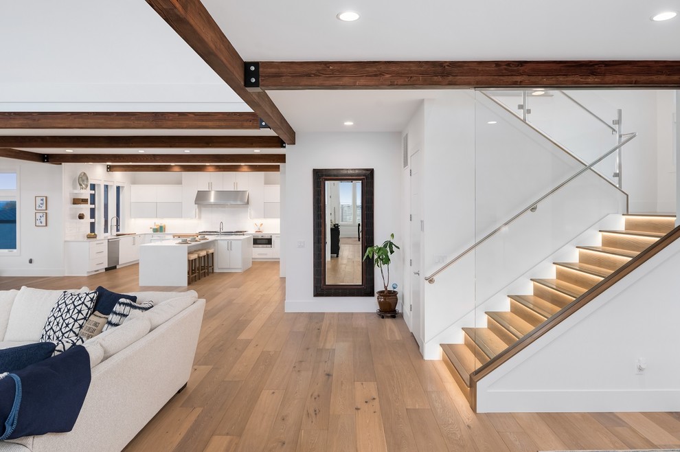 Design ideas for a large contemporary wood u-shaped staircase in Seattle with wood risers and glass railing.