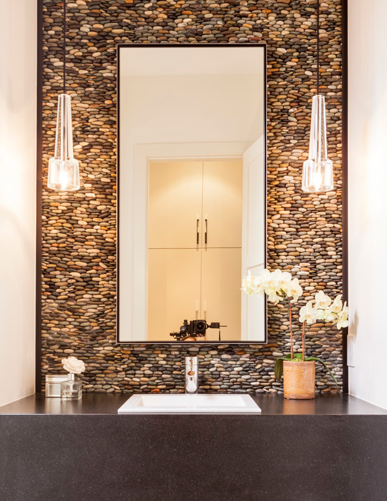 Photo of a contemporary powder room in Dallas with a drop-in sink, pebble tile and grey benchtops.