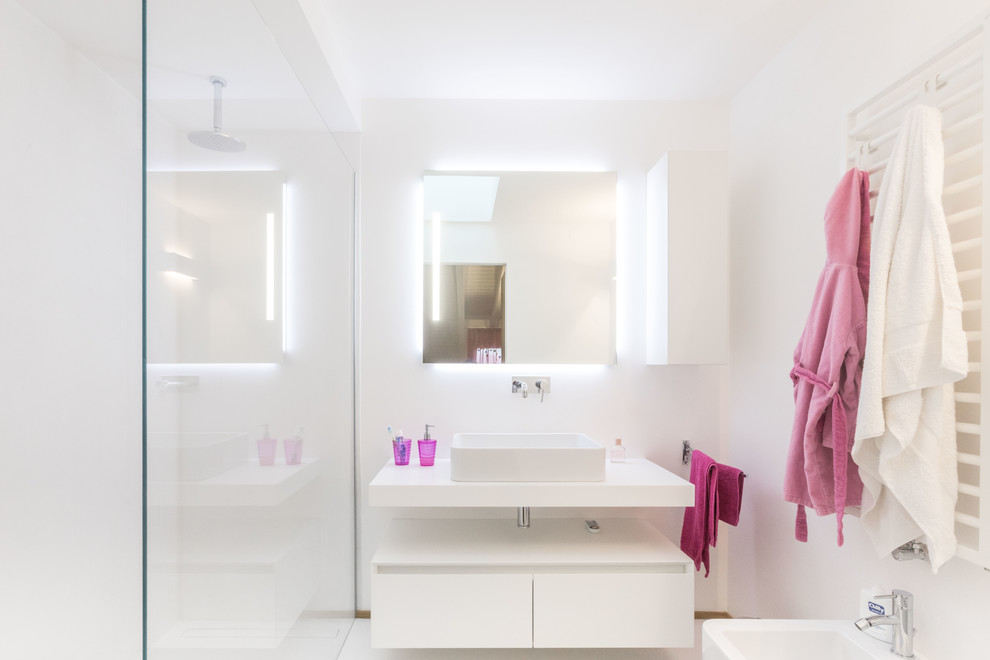 Design ideas for a contemporary bathroom in Milan with flat-panel cabinets, white cabinets, white walls, white floor and white benchtops.