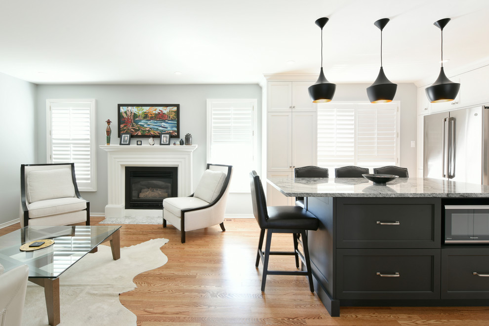 Inspiration for a large transitional u-shaped light wood floor and beige floor open concept kitchen remodel in Ottawa with an undermount sink, shaker cabinets, white cabinets, granite countertops, white backsplash, subway tile backsplash, stainless steel appliances, an island and gray countertops