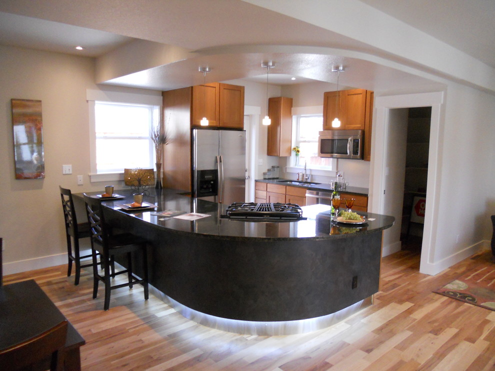 Example of a small transitional u-shaped light wood floor eat-in kitchen design in Denver with stainless steel appliances, shaker cabinets, medium tone wood cabinets, granite countertops and a peninsula