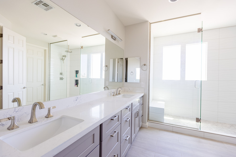 Large classic ensuite bathroom in Phoenix with shaker cabinets, grey cabinets, a double shower, white tiles, cement tiles, white walls, wood-effect flooring, a submerged sink, quartz worktops, grey floors, a hinged door, white worktops, a shower bench, double sinks and a built in vanity unit.