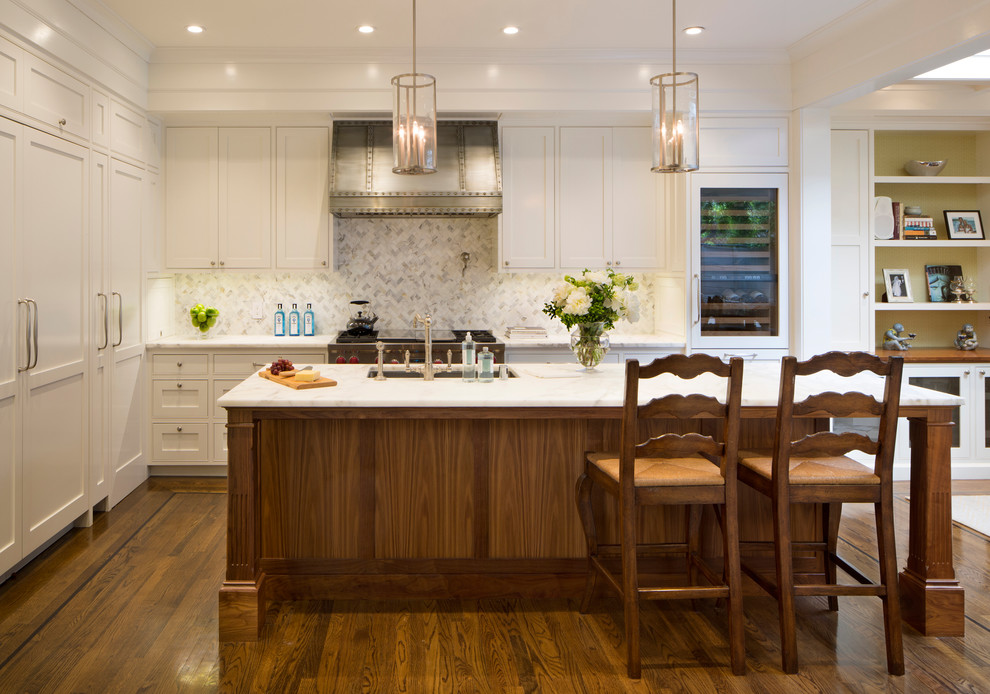 Design ideas for a large traditional l-shaped kitchen in San Francisco with an undermount sink, recessed-panel cabinets, white cabinets, marble benchtops, white splashback, panelled appliances, medium hardwood floors, with island and marble splashback.