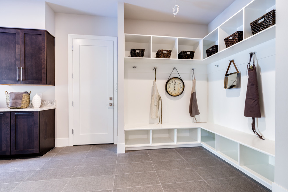 Photo of a large contemporary galley utility room in Seattle with an undermount sink, shaker cabinets, dark wood cabinets, granite benchtops, white walls, porcelain floors, a side-by-side washer and dryer, grey floor and multi-coloured benchtop.