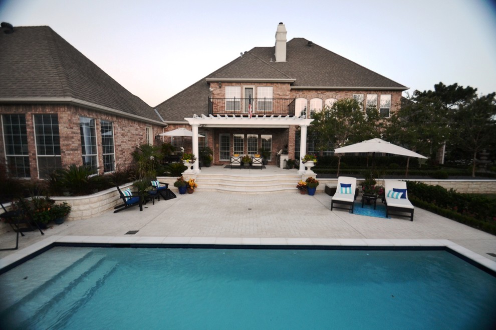 Pool - mid-sized backyard rectangular pool idea in Dallas