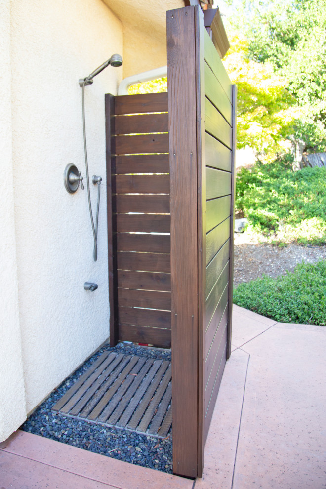 This is an example of a large mediterranean backyard patio in San Luis Obispo with an outdoor shower and concrete slab.