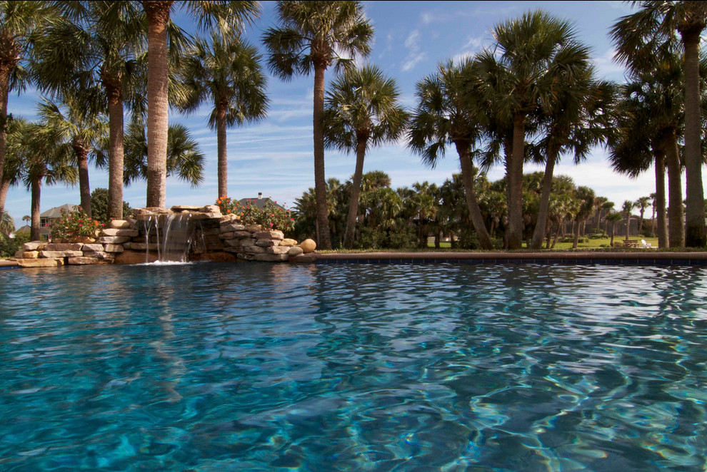 Large backyard stone and custom-shaped natural pool fountain photo in Jacksonville