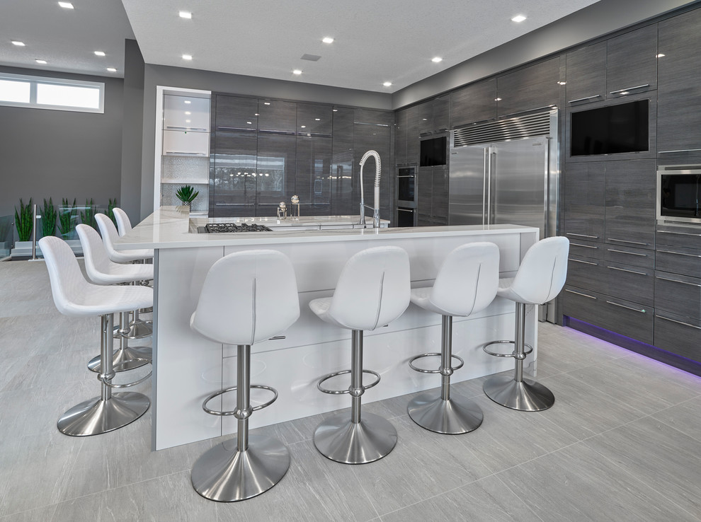 Inspiration for a contemporary u-shaped eat-in kitchen in Edmonton with an undermount sink, flat-panel cabinets, grey cabinets, quartzite benchtops, white splashback, porcelain splashback, stainless steel appliances, porcelain floors and with island.