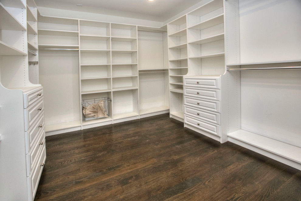 Design ideas for a large transitional gender-neutral walk-in wardrobe in New York with open cabinets, white cabinets, dark hardwood floors and brown floor.