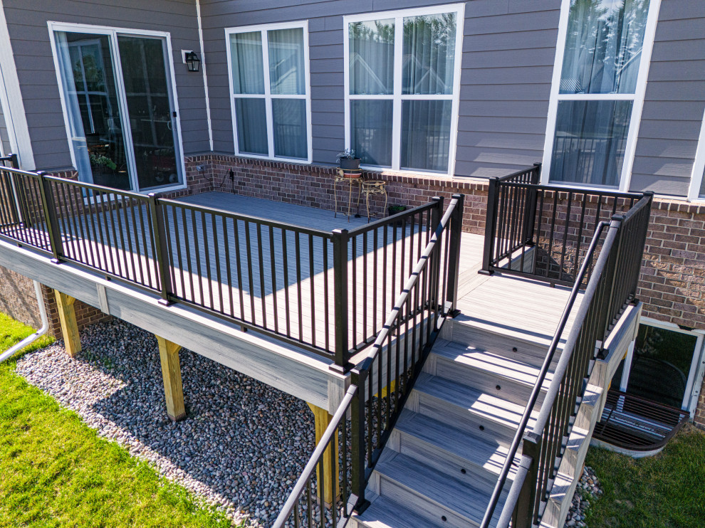 Mid-sized trendy backyard ground level metal railing deck photo with no cover