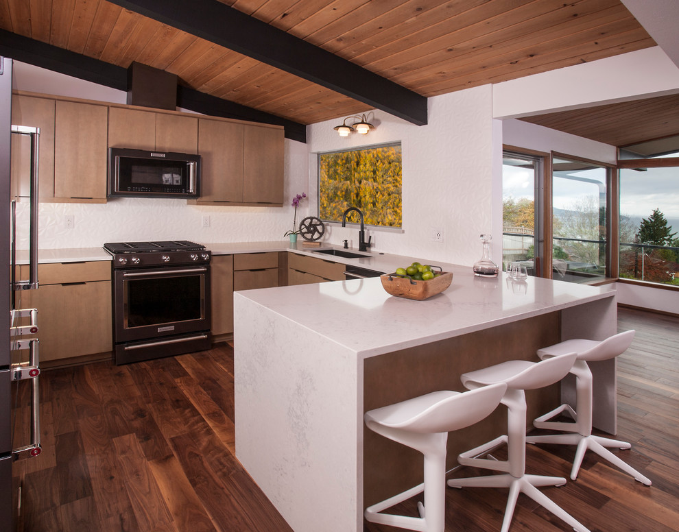 Contemporary u-shaped kitchen in Seattle with a single-bowl sink, flat-panel cabinets, brown cabinets, white splashback, stainless steel appliances, dark hardwood floors, a peninsula, brown floor and white benchtop.