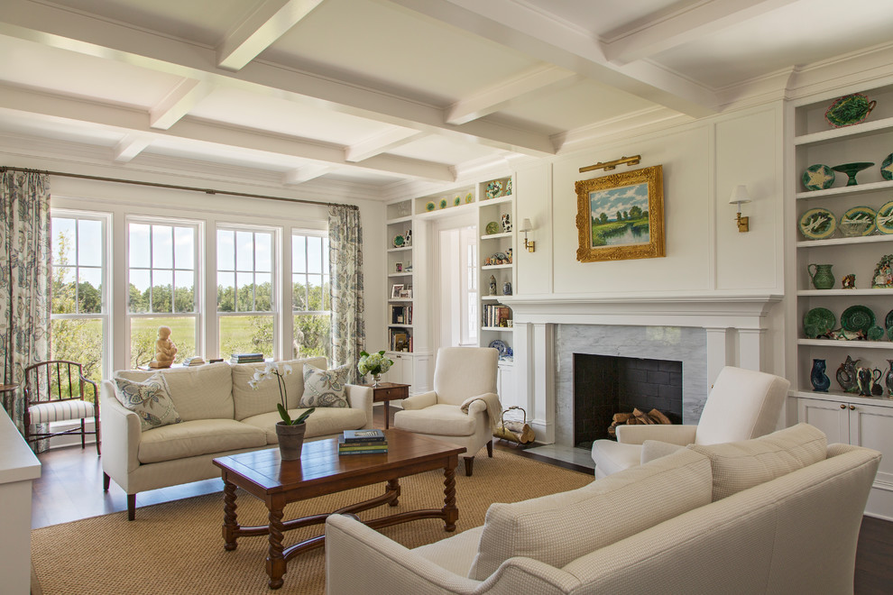 This is an example of a large beach style formal living room in Charleston with white walls, dark hardwood floors, a standard fireplace, a stone fireplace surround, no tv and brown floor.