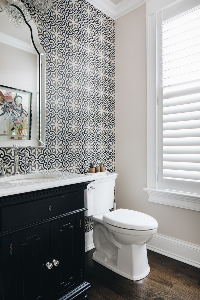 Design ideas for a small eclectic powder room in Chicago with beaded inset cabinets, black cabinets, a two-piece toilet, multi-coloured tile, porcelain tile, grey walls, medium hardwood floors, an undermount sink, marble benchtops and white benchtops.
