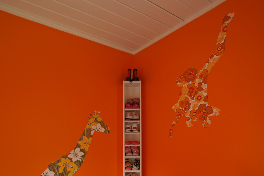 Design ideas for a midcentury gender-neutral kids' bedroom in Orange County with orange walls.