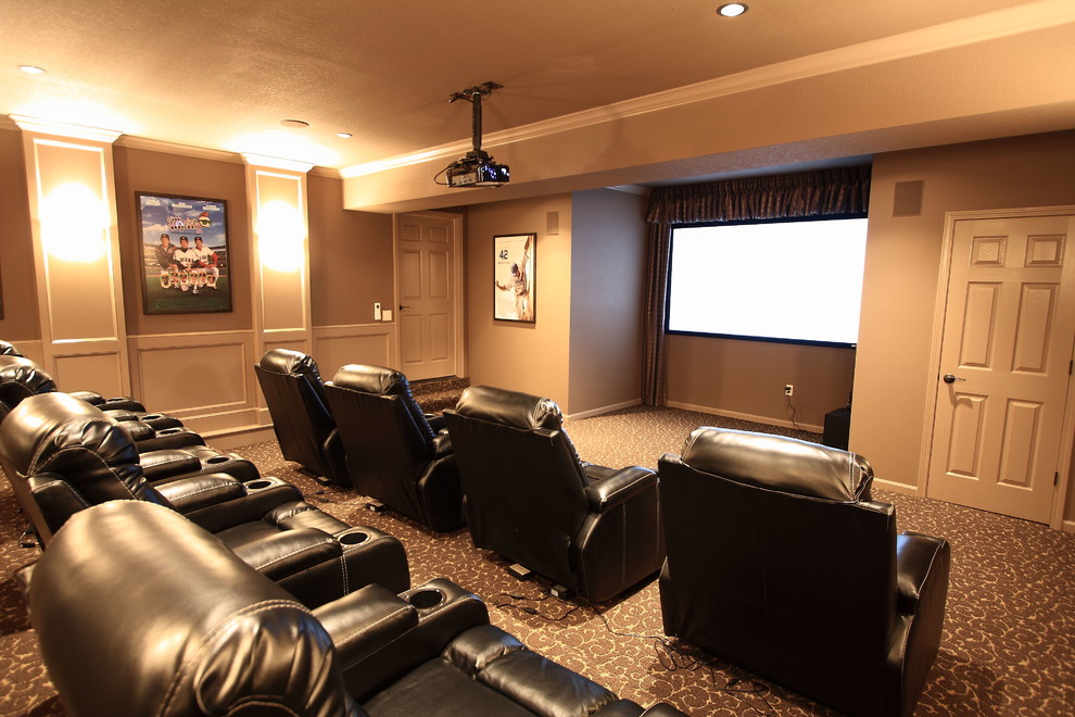 Large transitional enclosed home theatre in Kansas City with beige walls, carpet and a projector screen.