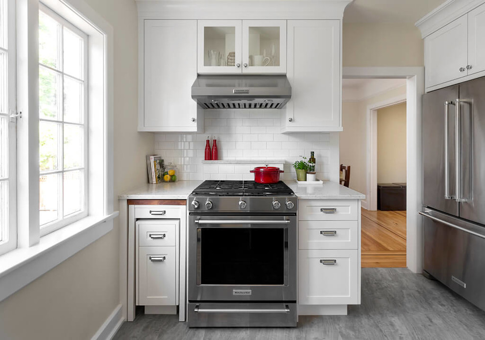 Example of a small transitional vinyl floor kitchen design in Vancouver with shaker cabinets, white cabinets, quartz countertops, white backsplash, subway tile backsplash and stainless steel appliances