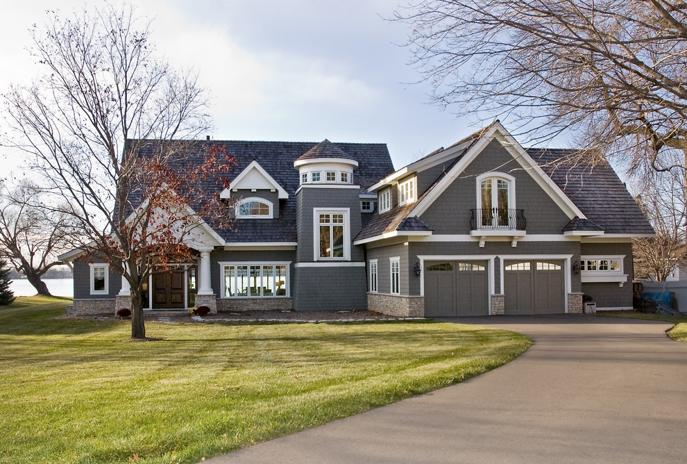 Inspiration for a large traditional two-storey exterior in Minneapolis with wood siding.