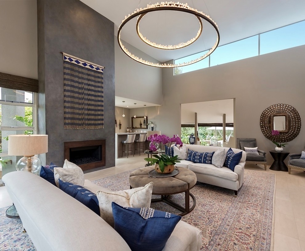 Large eclectic formal open concept living room in San Diego with grey walls, a standard fireplace, a metal fireplace surround, no tv, beige floor, vaulted and travertine floors.