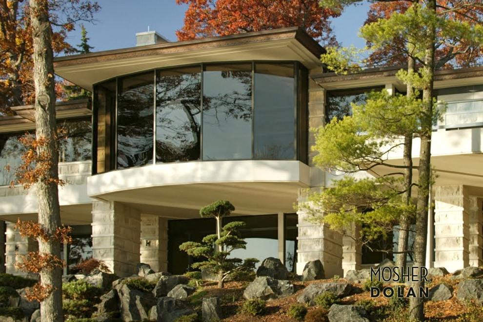 Home design - huge transitional three-story stone beige home design idea in Detroit