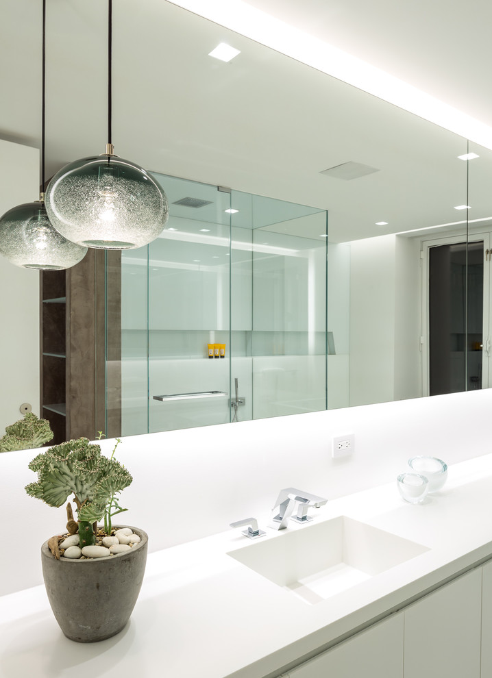 Design ideas for a mid-sized modern master bathroom in Chicago with flat-panel cabinets, white cabinets, white walls, ceramic floors, an integrated sink and solid surface benchtops.