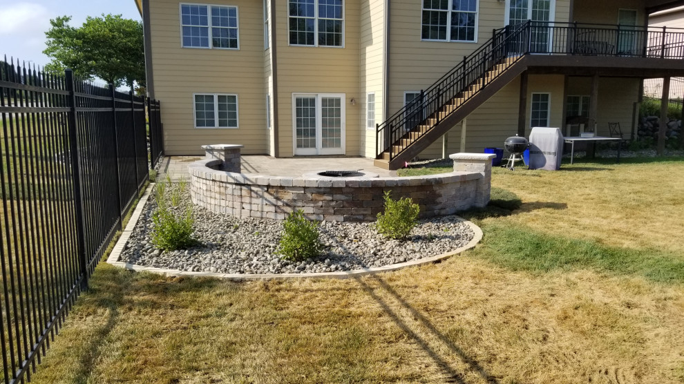 Example of a mid-sized backyard second story privacy and metal railing deck design with a roof extension