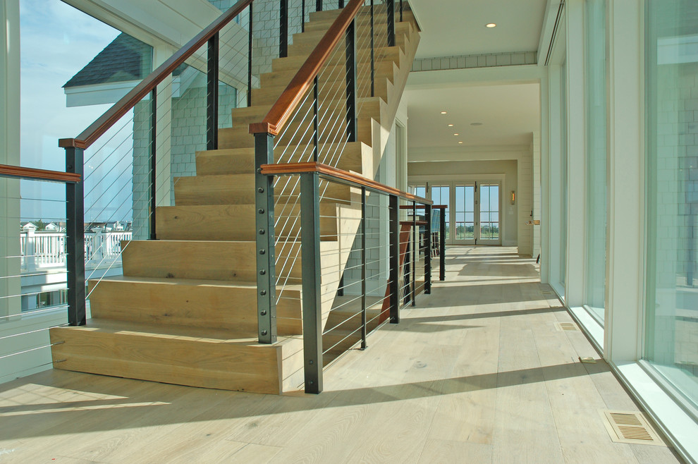 This is an example of a modern wood staircase in Philadelphia with wood risers and cable railing.