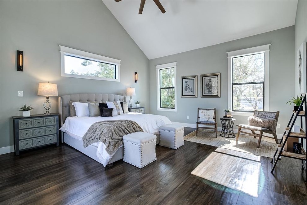 Photo of a large arts and crafts master bedroom in Houston with grey walls, dark hardwood floors, no fireplace and brown floor.