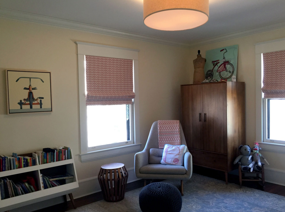 Photo of a mid-sized midcentury gender-neutral nursery in New York with yellow walls, carpet and blue floor.
