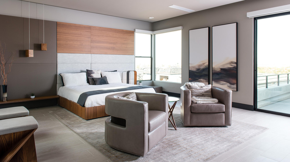Photo of a large contemporary master bedroom in Las Vegas with brown walls, porcelain floors and grey floor.