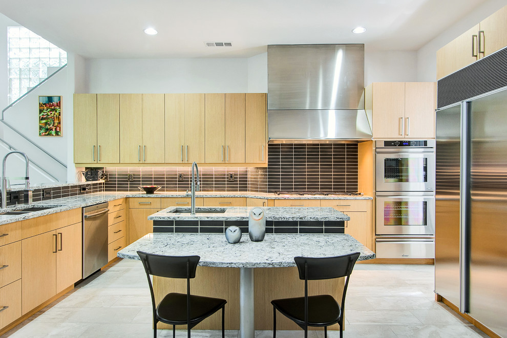 Photo of a mid-sized midcentury u-shaped separate kitchen in Dallas with an undermount sink, flat-panel cabinets, light wood cabinets, quartz benchtops, black splashback, ceramic splashback, stainless steel appliances, porcelain floors and multiple islands.