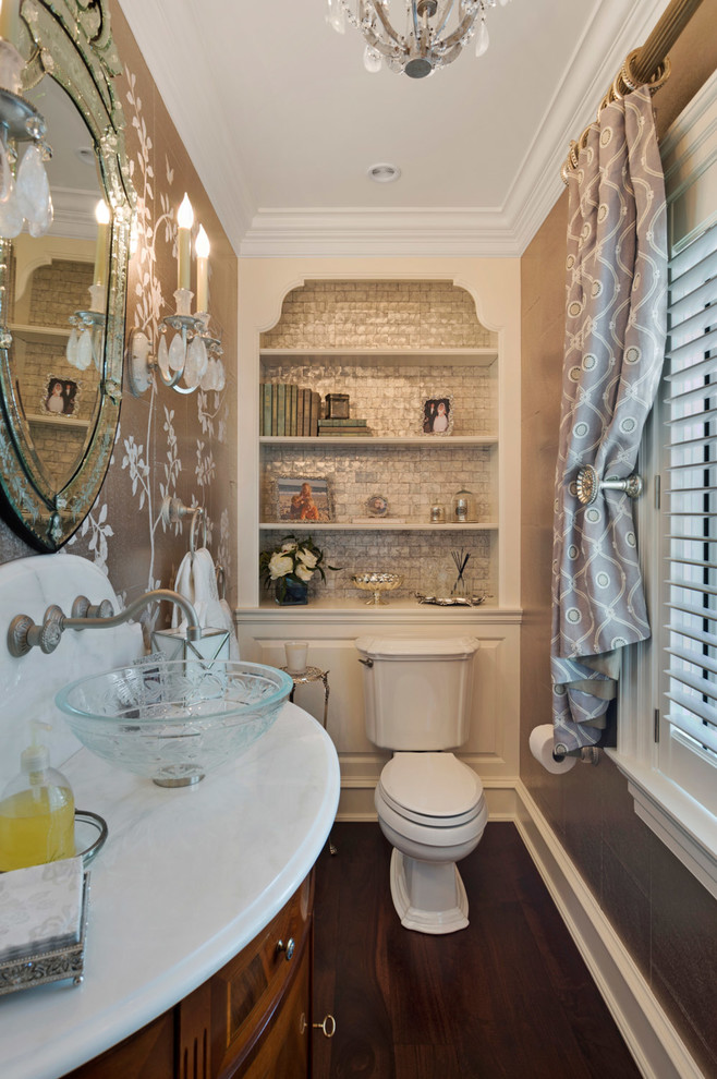 This is an example of a small contemporary powder room in Philadelphia with flat-panel cabinets, dark wood cabinets, a one-piece toilet, dark hardwood floors, a vessel sink, marble benchtops, brown walls, brown floor, gray tile and metal tile.