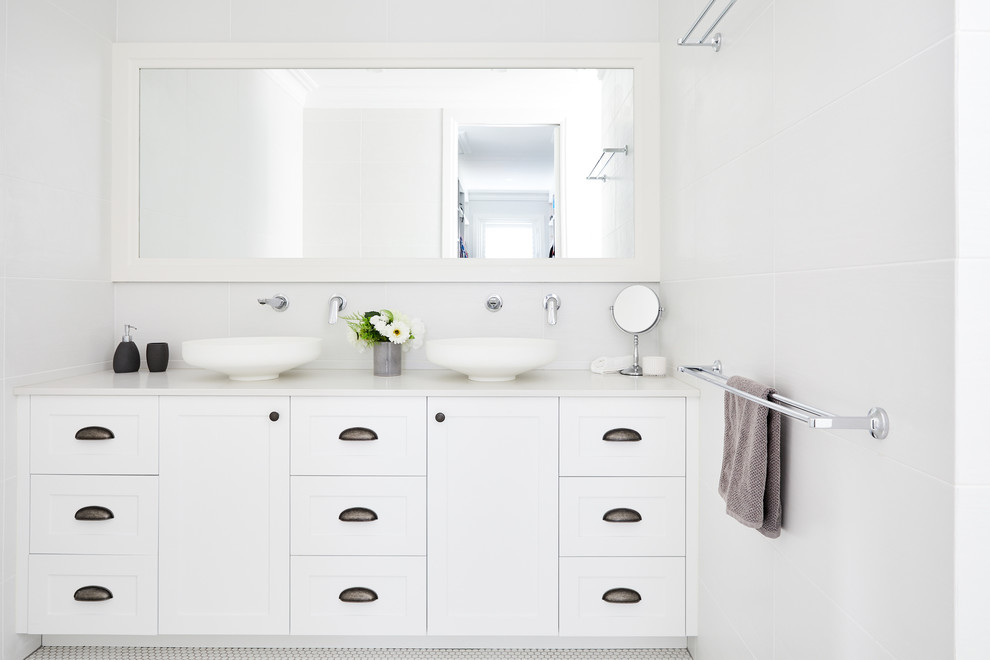 Inspiration for a mid-sized beach style 3/4 bathroom in Sydney with shaker cabinets, white cabinets, white tile, porcelain tile, white walls, porcelain floors, a vessel sink, white floor and white benchtops.
