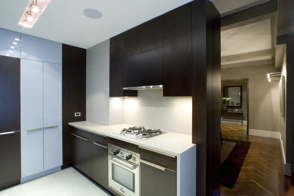 Modern kitchen in New York with flat-panel cabinets and dark wood cabinets.