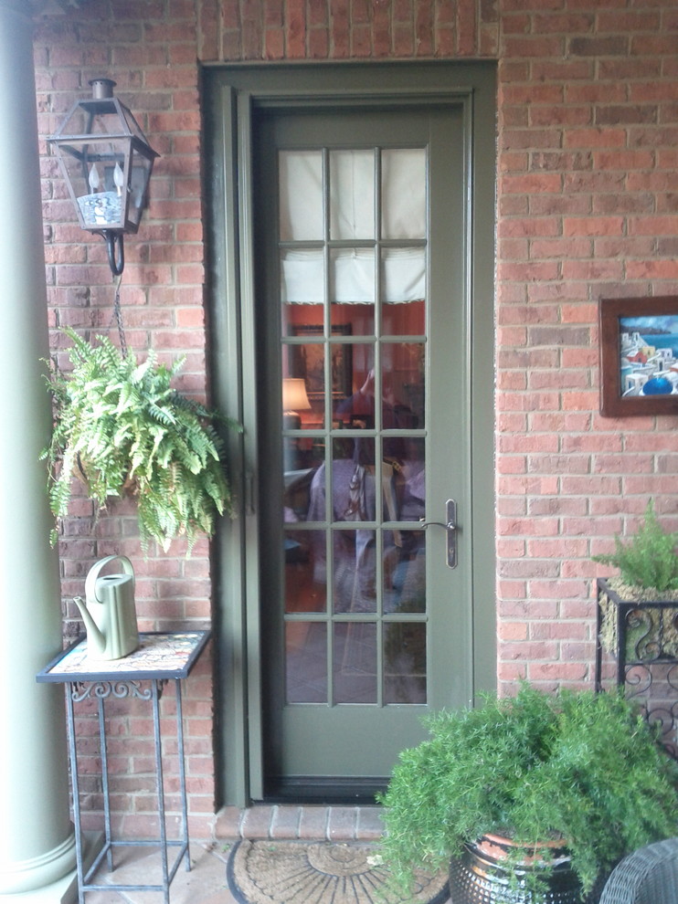 This is an example of a small traditional front door in Louisville with a single front door and a green front door.