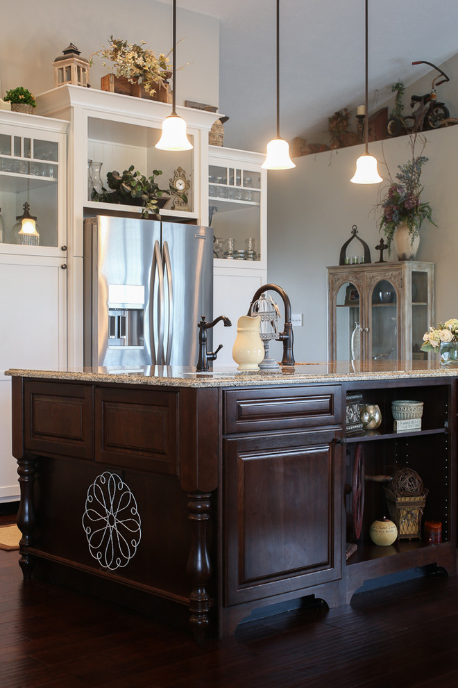Open concept kitchen - transitional l-shaped dark wood floor open concept kitchen idea with a farmhouse sink, shaker cabinets, white cabinets, quartz countertops, white backsplash, stainless steel appliances and an island