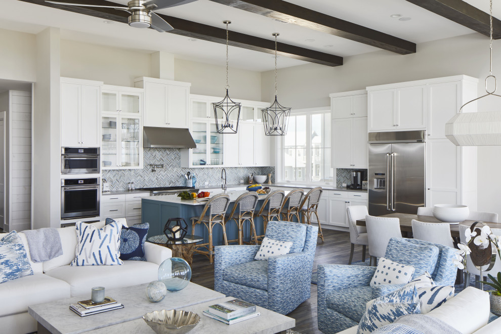 Inspiration for an expansive beach style open concept family room in Other with grey walls, vinyl floors, a wall-mounted tv, brown floor and exposed beam.