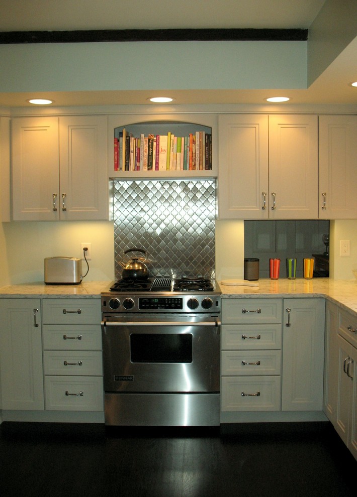 Example of a transitional l-shaped dark wood floor eat-in kitchen design in Boston with recessed-panel cabinets, white cabinets, quartz countertops, metallic backsplash, metal backsplash, stainless steel appliances and no island