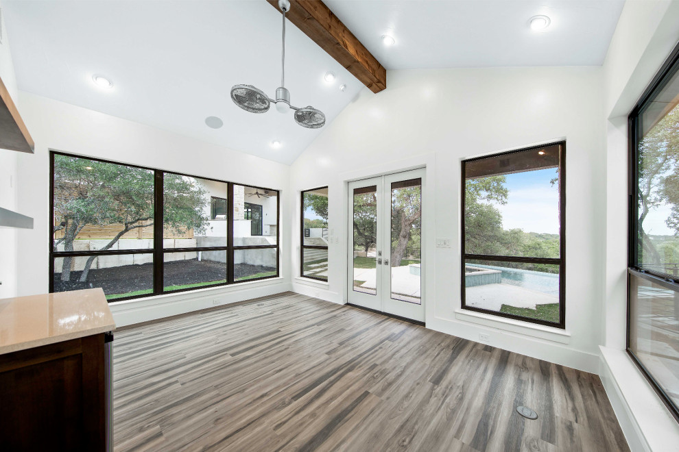Inspiration for a mid-sized transitional multipurpose gym in Austin with white walls, laminate floors and beige floor.