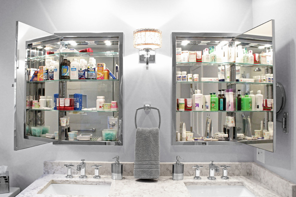 Corner shower - mid-sized transitional master gray tile and porcelain tile porcelain tile corner shower idea in Boston with shaker cabinets, dark wood cabinets, a two-piece toilet, gray walls, an undermount sink and quartz countertops