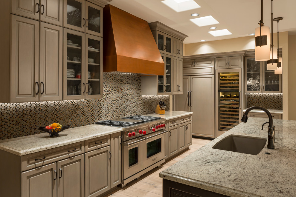 Inspiration for a mid-sized transitional galley light wood floor and beige floor open concept kitchen remodel in Phoenix with a single-bowl sink, raised-panel cabinets, beige cabinets, granite countertops, multicolored backsplash, mosaic tile backsplash, an island and stainless steel appliances
