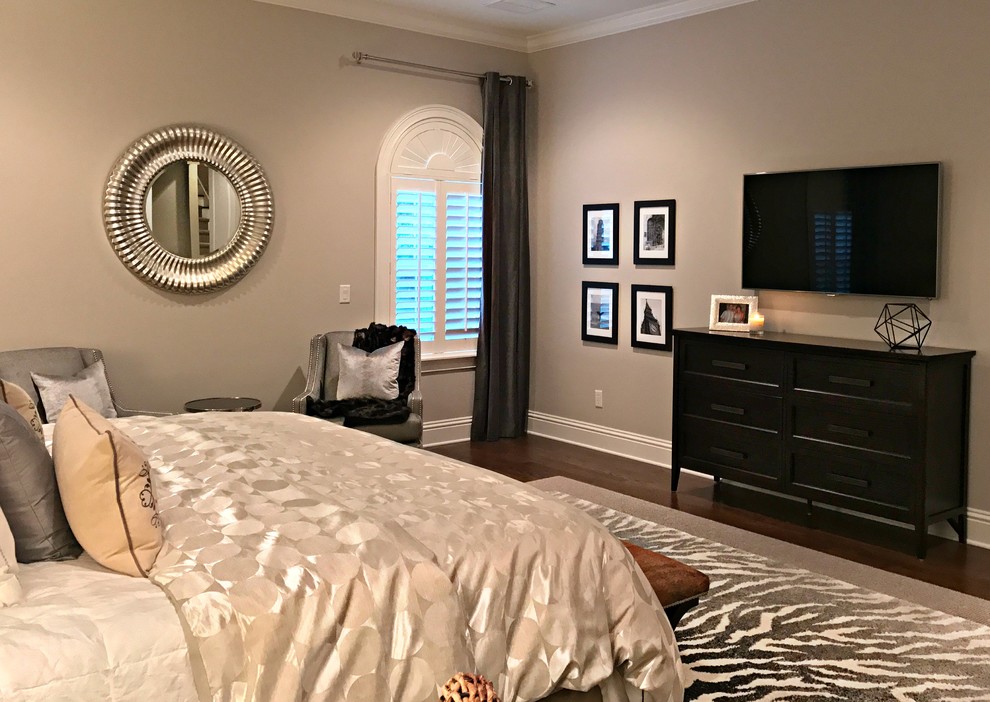 This is an example of a mid-sized transitional master bedroom in Tampa with beige walls, dark hardwood floors, no fireplace and brown floor.