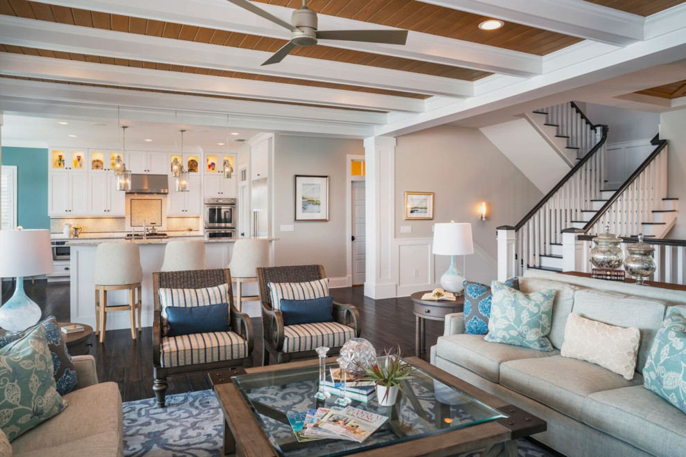 This is an example of a mid-sized beach style open concept living room in Tampa with grey walls, dark hardwood floors, a standard fireplace, a tile fireplace surround, a built-in media wall and brown floor.