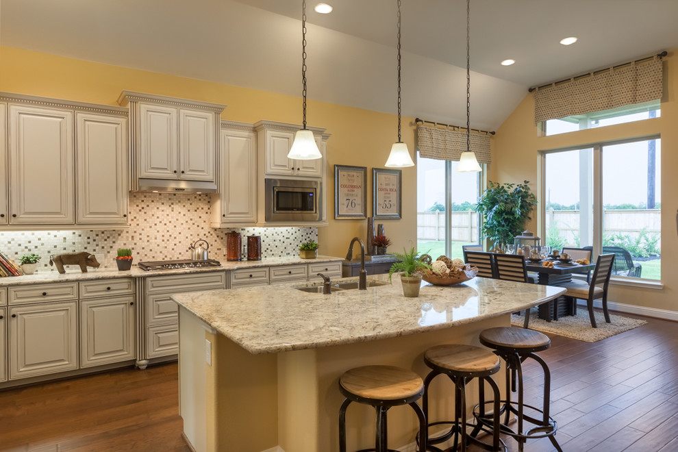 Inspiration for a country eat-in kitchen in Houston with white cabinets, multi-coloured splashback, ceramic splashback, stainless steel appliances, medium hardwood floors and with island.