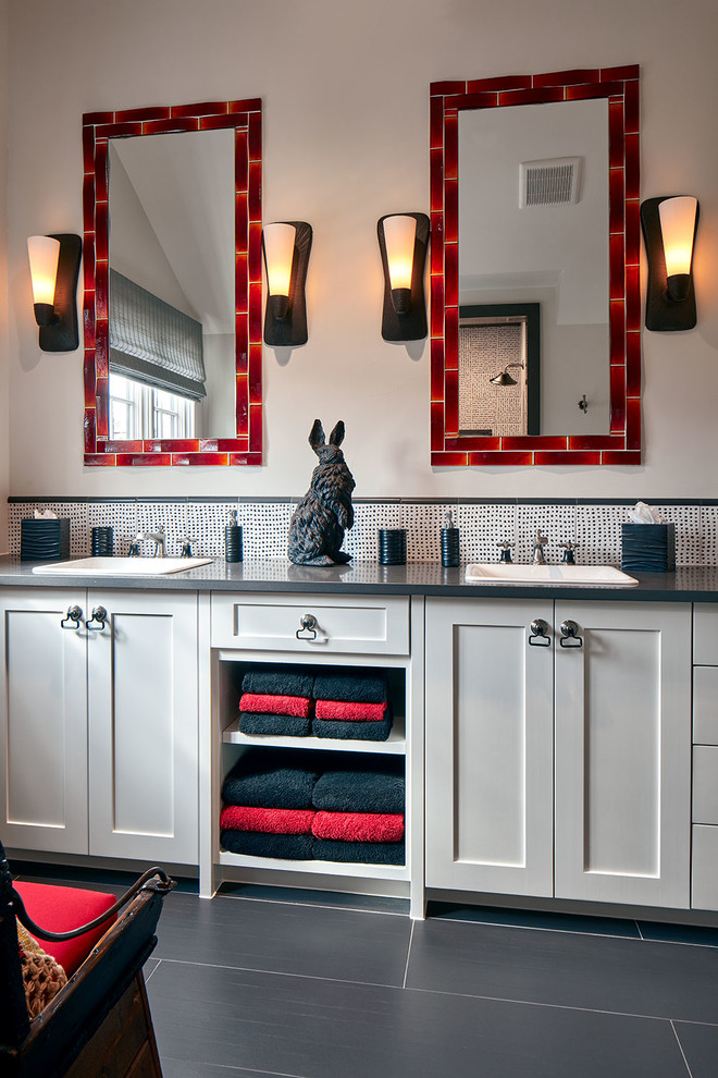 This is an example of a large transitional kids bathroom in Dallas with recessed-panel cabinets, white cabinets, a drop-in sink, black benchtops, porcelain floors, black floor, multi-coloured tile, glass tile, beige walls and granite benchtops.