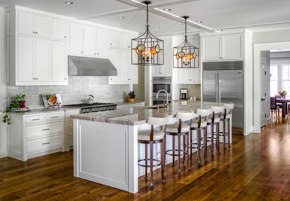 Inspiration for a large traditional l-shaped separate kitchen in Dallas with recessed-panel cabinets, white cabinets, grey splashback, stainless steel appliances, with island, an undermount sink, dark hardwood floors, brown floor and grey benchtop.