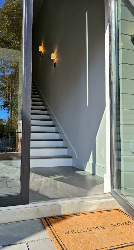 Staircase - huge transitional wooden straight wood railing staircase idea in DC Metro with painted risers