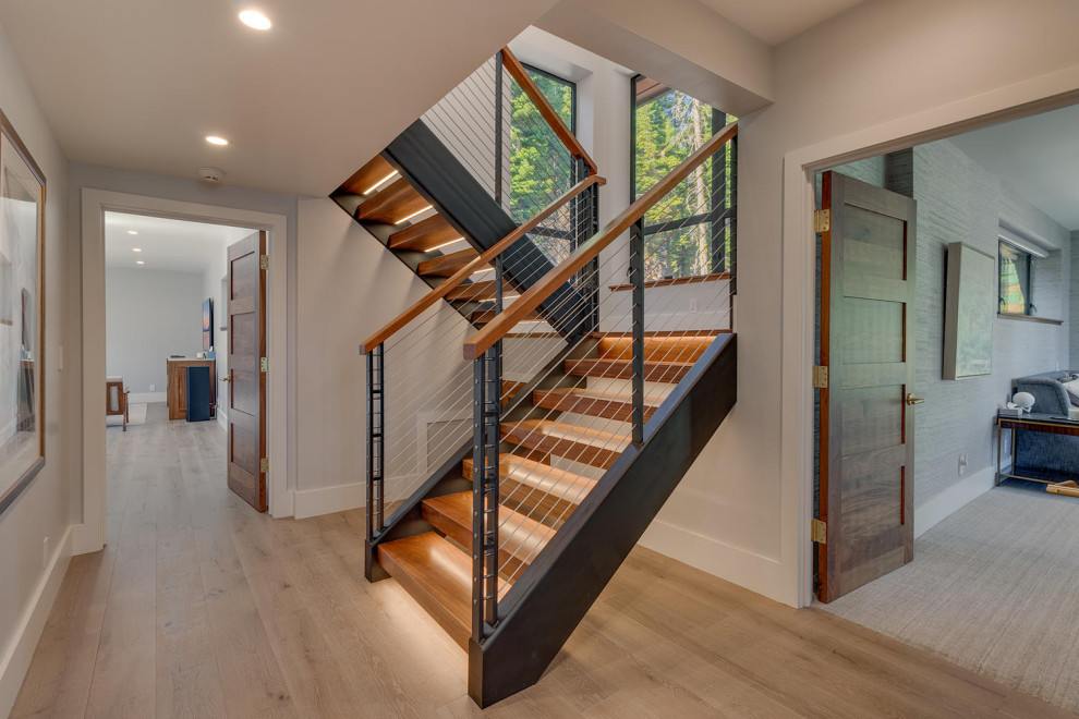 Inspiration for a large contemporary wood u-shaped staircase in Sacramento with wood risers and mixed railing.