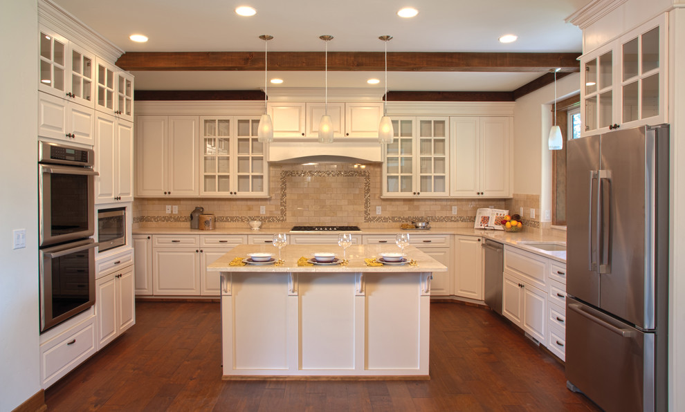Inspiration for a transitional medium tone wood floor kitchen remodel with a drop-in sink, raised-panel cabinets, white cabinets, beige backsplash, stainless steel appliances and an island