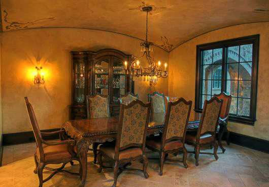 Photo of a large traditional separate dining room in Charlotte with yellow walls and travertine floors.